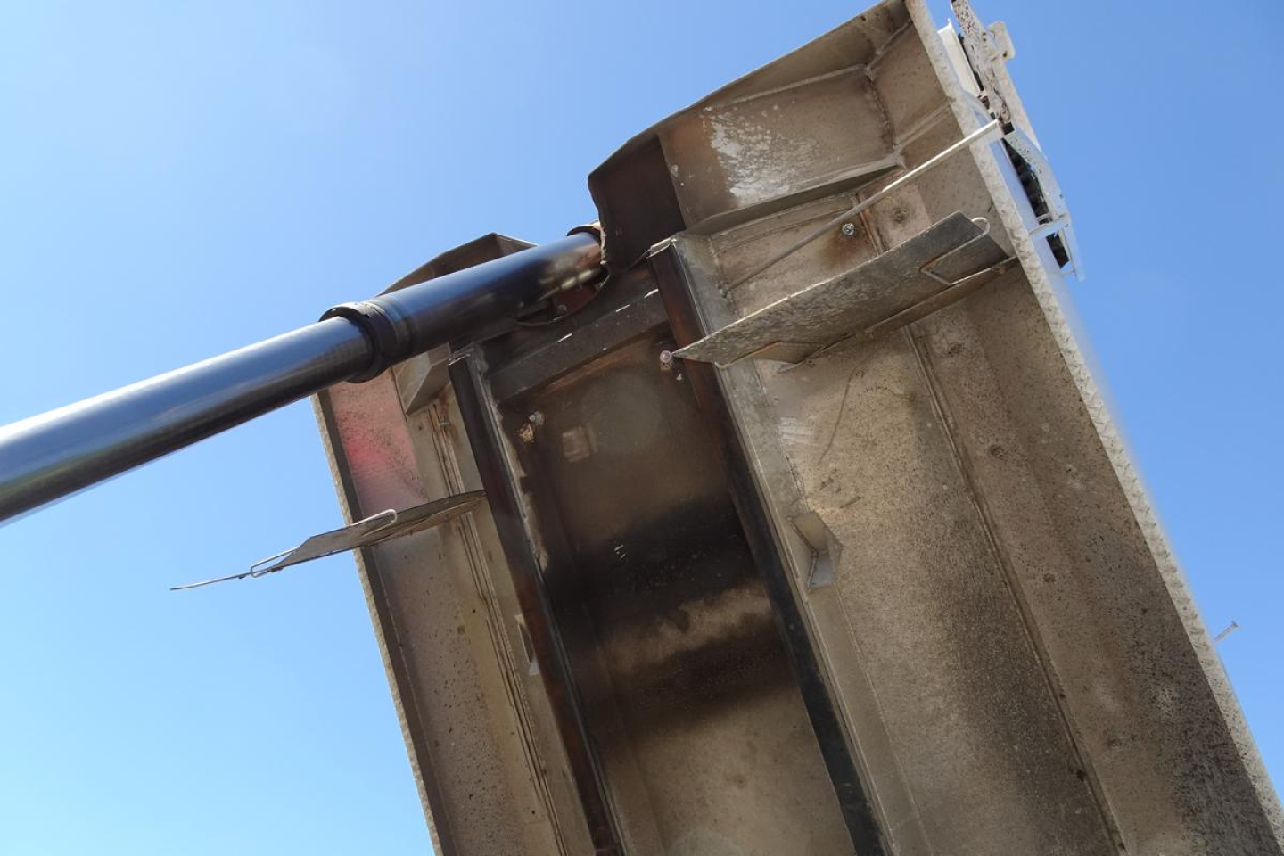 Dump truck bed and hydraulic hoist for a Mack CV (Granite) CV713 showing hydraulic cylinder and metal bed edges.