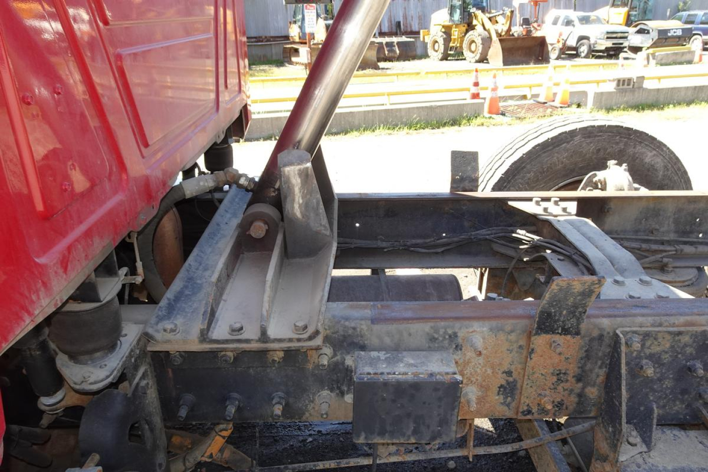 Mack CV Granite CV713 truck rear chassis and suspension components with hydraulic support arm visible.
