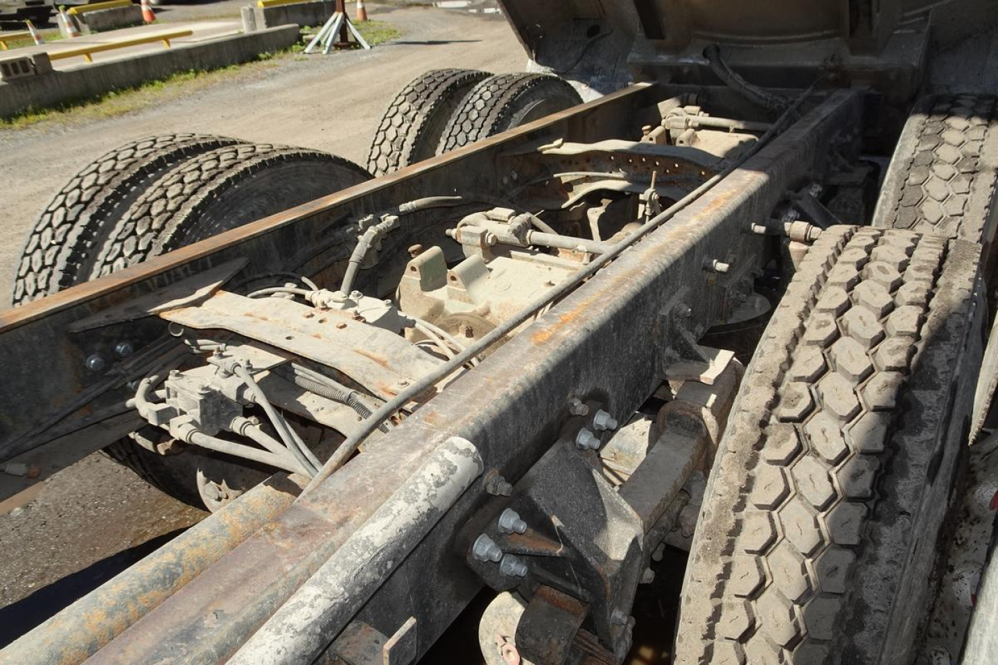 Mack CV Granite CV713 truck chassis undercarriage showing dual rear axles and tired frame with rust-friendly metal surfaces.