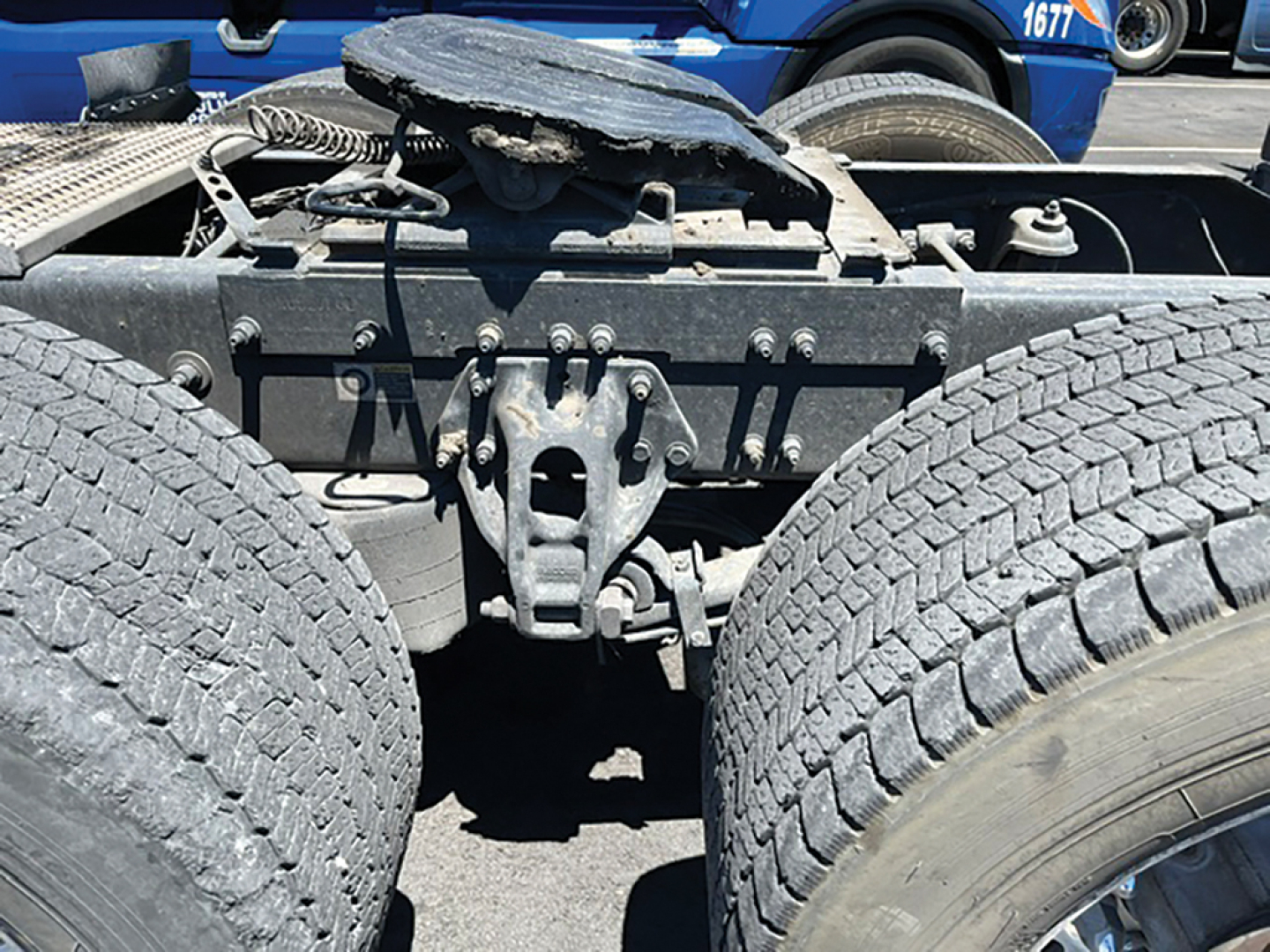 Rear chassis of a Peterbilt 579 tractor showing dual rear dual tires and fifth wheel mounting area with various mounting brackets and hardware.