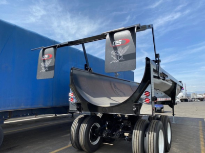 CPS Rock End Dump trailer viewed from rear-left showing dual-tire axle and dump body with CPS branding on flags.