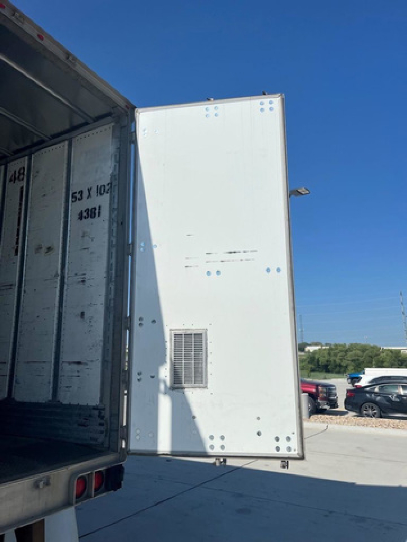 Trailer rear door of a utility van with white exterior and an air vent; open side door reveals interior trailer walls. 2014 utility van with stock U91087.