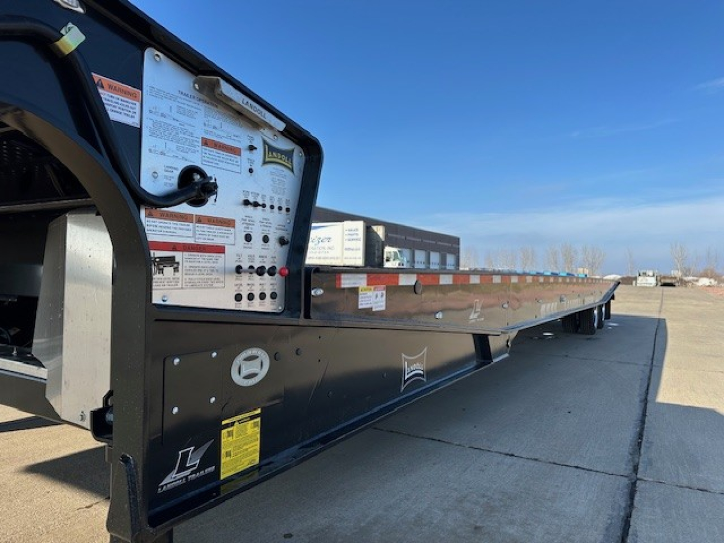 Landoll 440 trailer deck and control panel side showing operating placards and stickers.