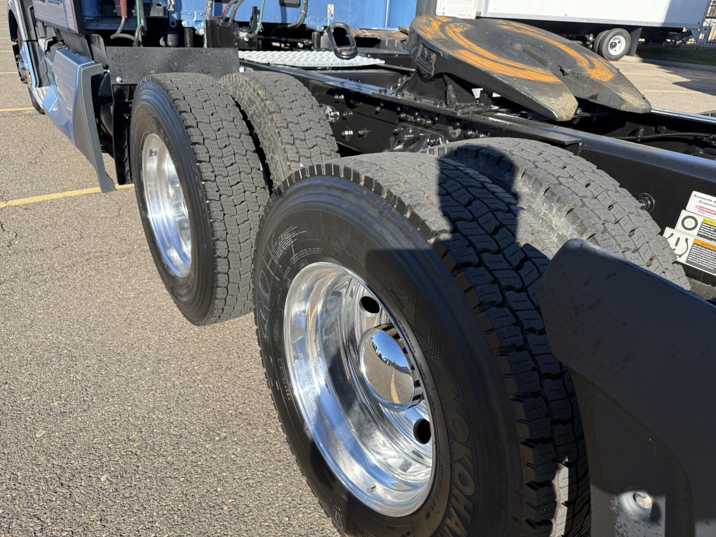 Kenworth T680 truck chassis showing dual rear axles and chrome wheels with tires.
