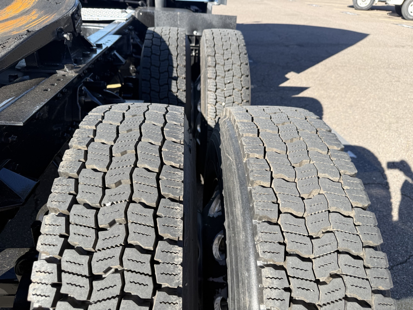 Kenworth T680 truck chassis showing dual rear tires and tread detail.