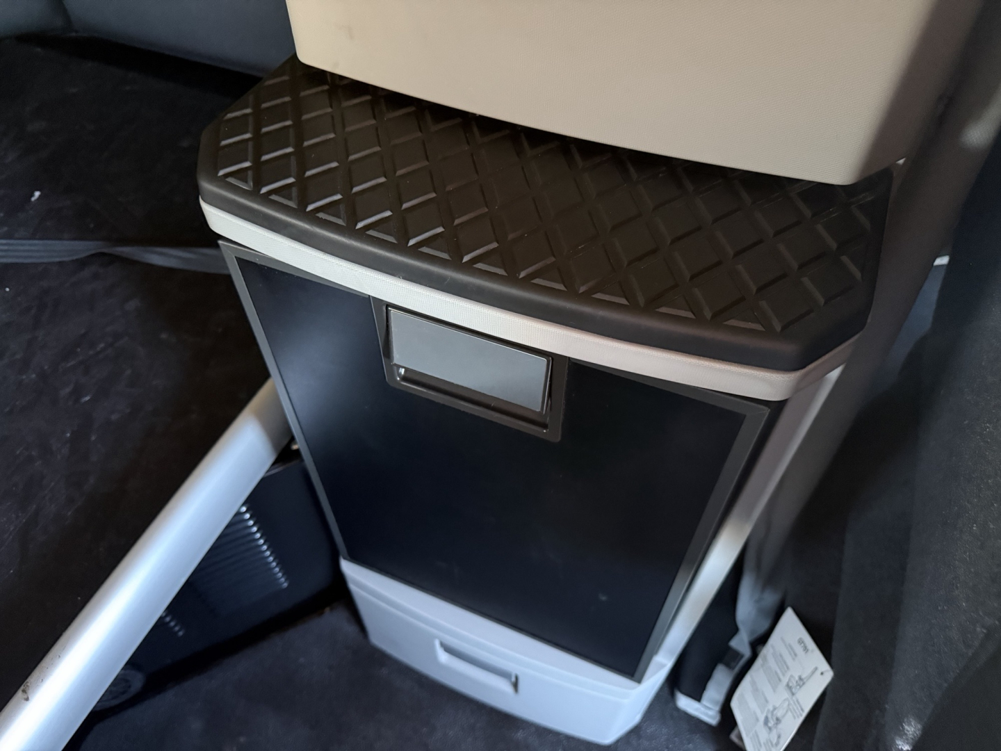 Kenworth T680 interior showing step storage cabinet and black textured step plate with silver trim.