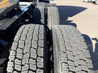 Kenworth T680 truck chassis showing dual rear tires and tread detail.