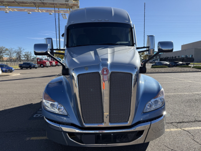Kenworth T680 front view showing dual mesh chrome grilles, emblem, and headlights; large mirrors; hood and bumper details.