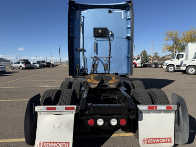 Kenworth T680 rear view showing fifth wheel, drivetrain, and mud flaps with Kenworth logos.