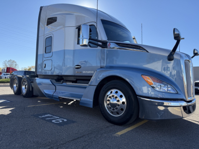 Kenworth T680 truck in view showing 2013? Not sure; but visible text on sticker: VIN/other; but legible: 'Kenworth' emblem on hood, side shows 'VIN: 1XKYD49X7PJ245143' and stock '0632991' in context. The image mainly shows a grey Kenworth T