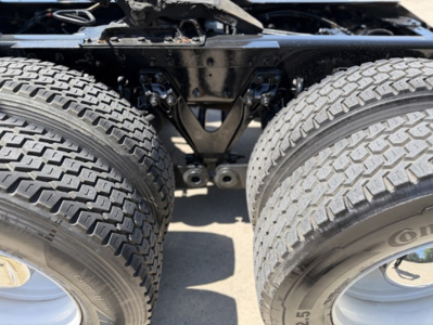 Kenworth T680 rear dual rear tires and chassis framing as seen from below showing suspension and axle assembly.