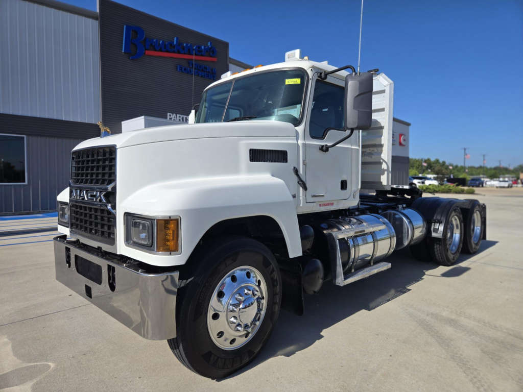 Mack Pinnacle heavy-duty tractor truck in white, front-left view showing cab, dual rear axles, chrome fuel tanks, and badge
