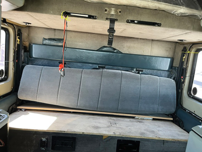 Kenworth W900L area showing rear sleeper cabin and cargo area with bench seat and storage platform