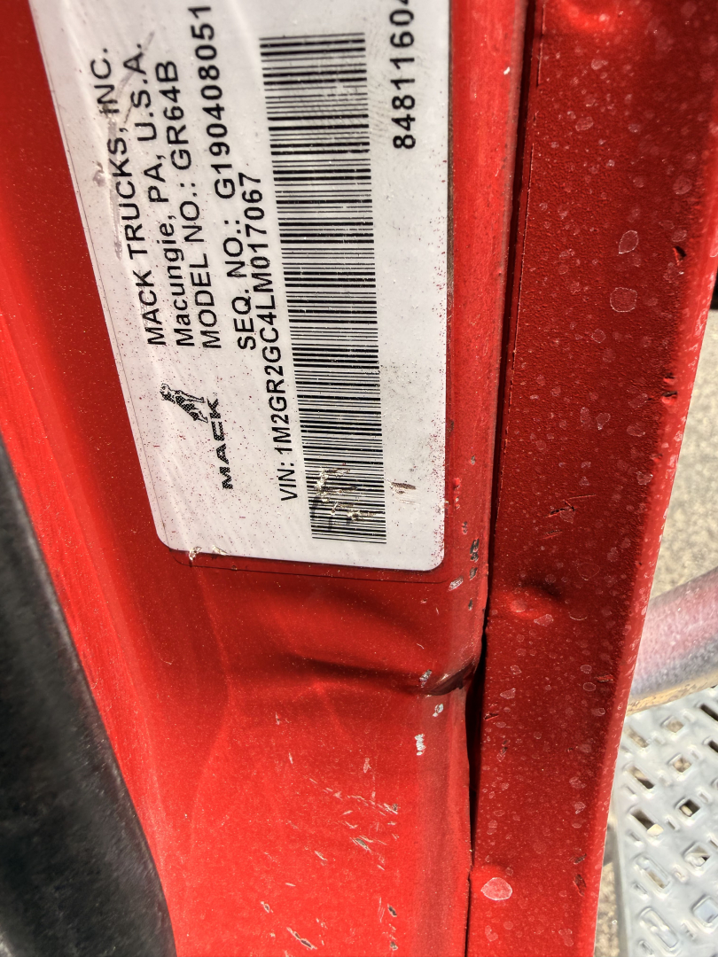 Label on red truck door showing VIN, stock number, model and frame info. Text includes: MACK TRUCKS INC, MODEL NO. G815A, SERIAL NO. 19040801, VIN: 1M2GR2GC4LM017067, STOCK NO: B3720P, etc.