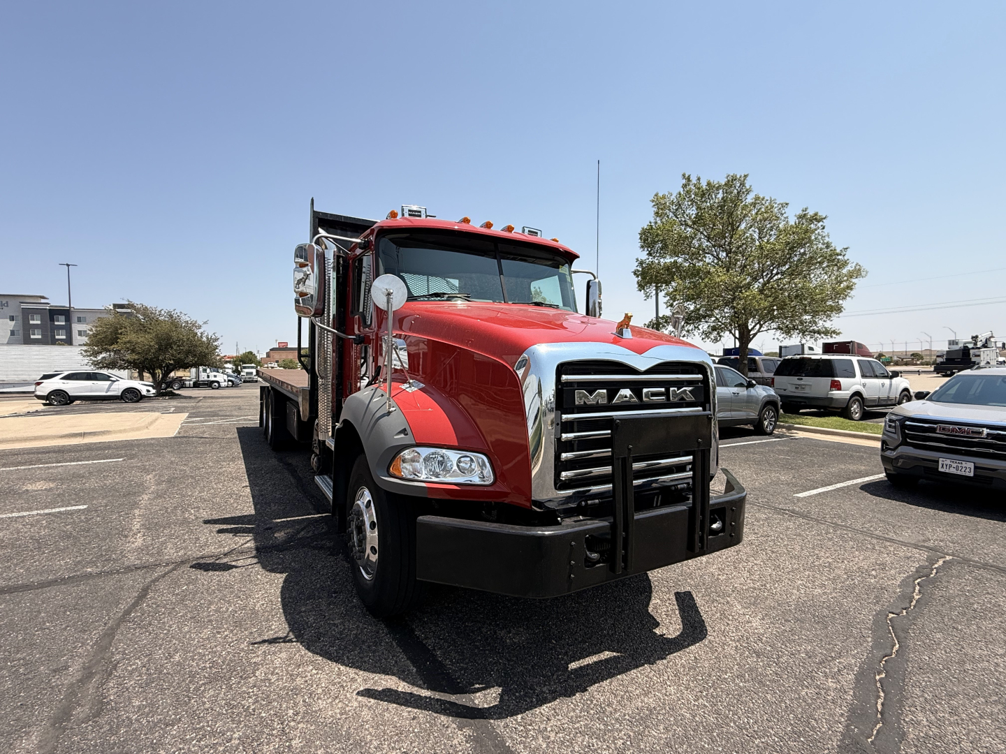 Red 2020 Mack Granite in a parking lot, front view with black grille guard and chrome bumper. VIN plate and stock number not visible.