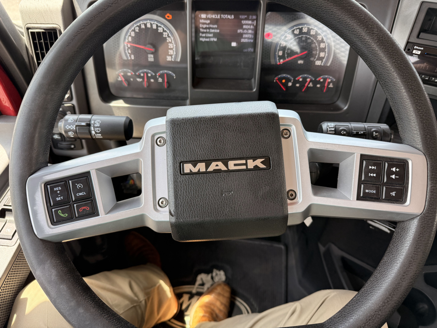 Mack Granite truck steering wheel with dashboard gauges and control buttons visible