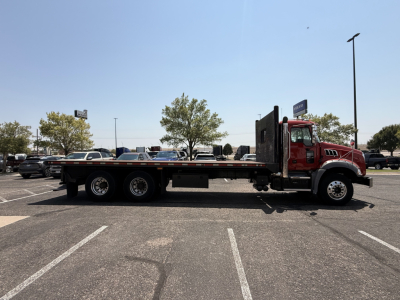 Side view of a red 2020 Mack Granite flatbed truck in a dealership lot with stock number B3720P and VIN 1M2GR2GC4LM017067.