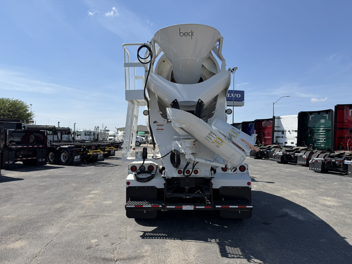 Volvo VHD64B300 mixer truck rear view showing concrete mixer drum and chute assembly with Beck branding.
