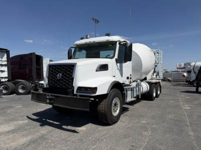 Volvo VHD64B300 mixer truck in white, front three-quarter view, with cement mixer drum visible on rear chassis.