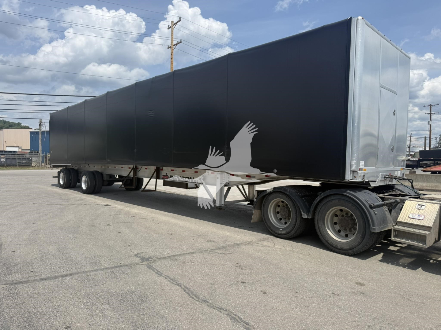 Curtainside trailer showing long black side panels and rear hatch, triple-axle undercarriage, Benson Conestoga trailer. VIN 1TTF532A7P3350337 visible in listing context.