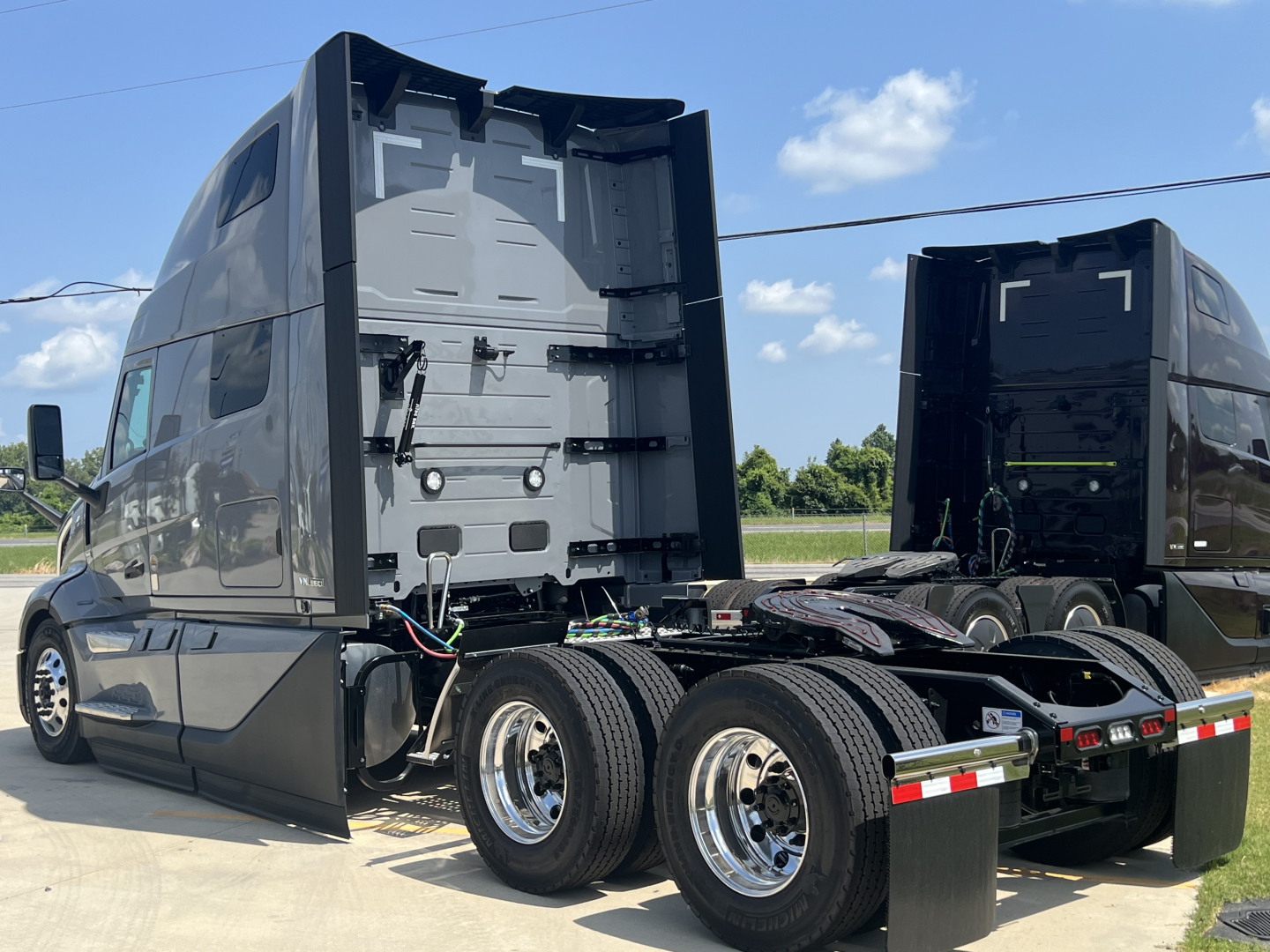 Volvo VNL64T860 truck cab and chassis showing rear view of dual axle with exposed frame and wiring harnesses