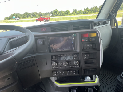 Dashboard and center console of a Volvo truck cabin showing control panel, touchscreen display, climate controls, and various buttons.