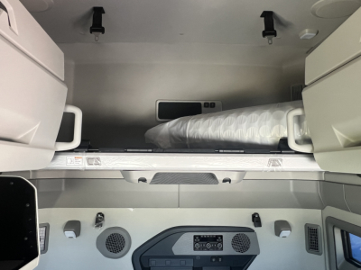 Volvo VNL64T860 truck cab interior with sleeper berth and storage cabinets visible, carpeted bunk area and control panel at lower center.