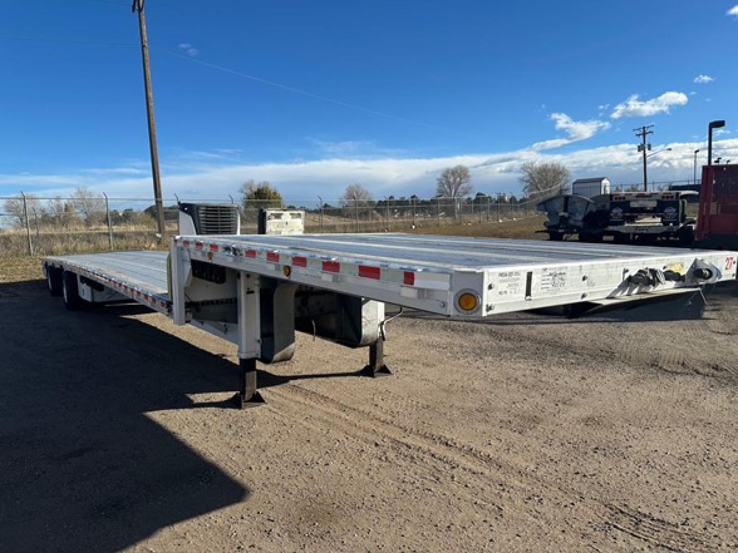 Aluminum drop deck trailer showing flatbed with suspension and landing gear, 2018 Reitnouer Maxmiser, stock UE11193, VIN 150117680541, used condition.
