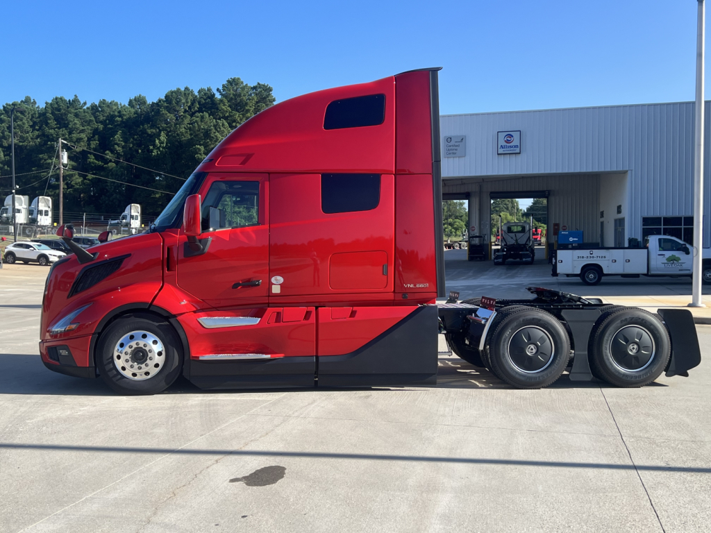 Red Volvo VNL64T660 tractor in-service showing cab and rear wheels