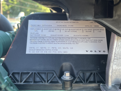 Engine info plate on Volvo VNL64T660 showing engine family, model, serial, and various specs. Visible: text blocks with engine details and Volvo branding.