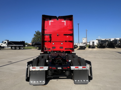 Volvo VNL64T660 cab rear view showing red sleeper with chassis and dual rear axles.