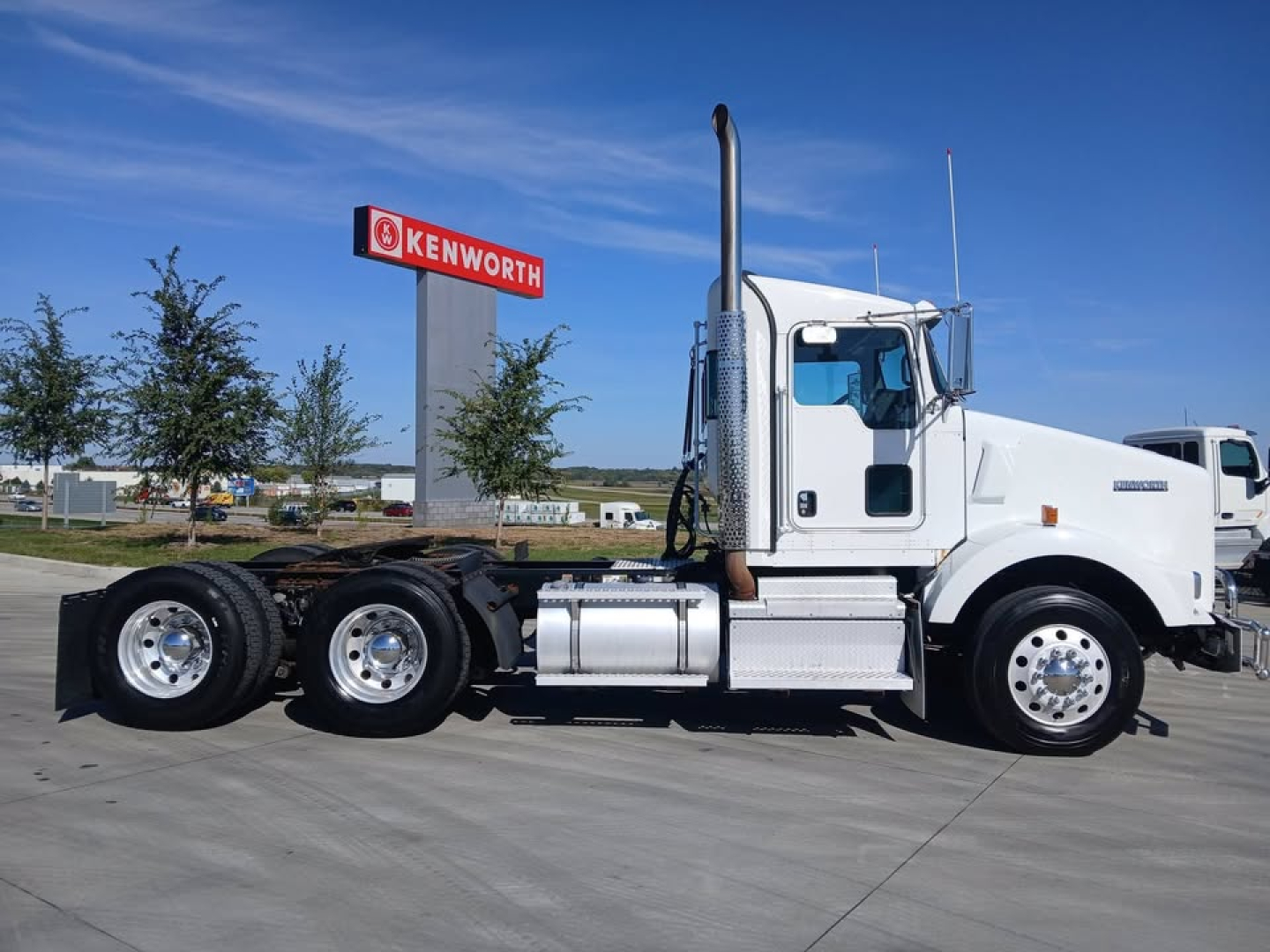 Kenworth T800 conventional sleeper truck side view showing cab, fuel tanks, and dual rear axles.
