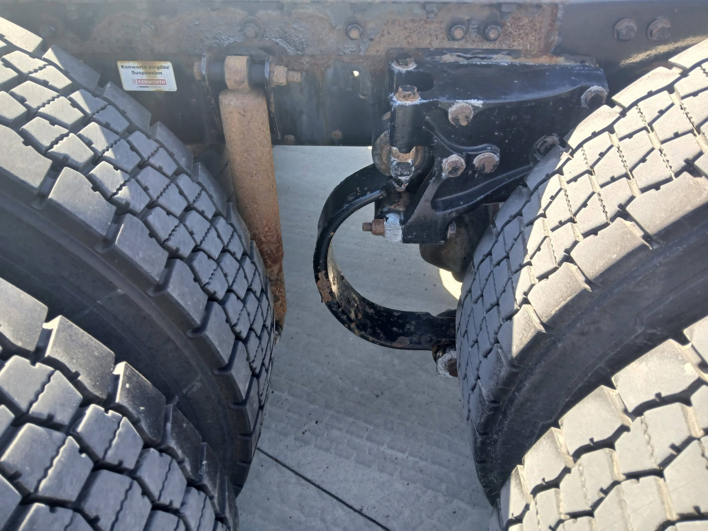 Kenworth T800 truck rear undercarriage showing dual rear tires, suspension components, and frame with electrical/air line routing.