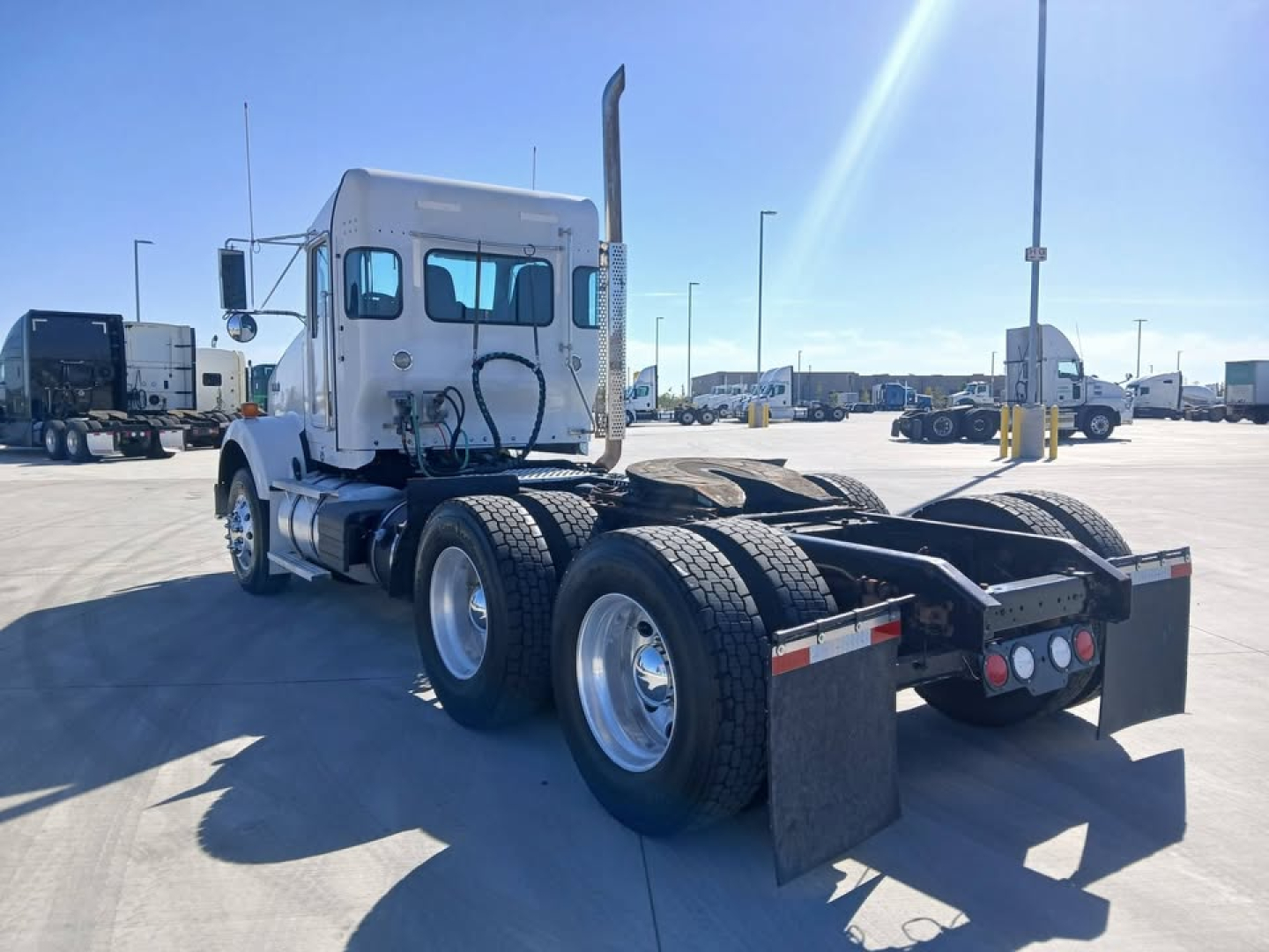 Kenworth T800 tractor rear view showing dual rear axles and mud flaps.