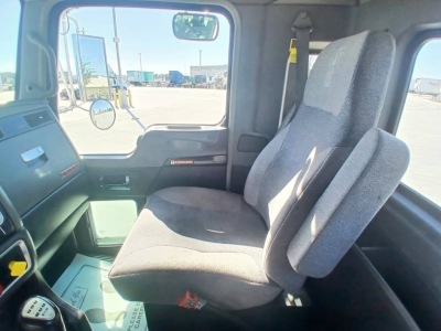 Kenworth T800 truck interior shows driver's seat and passenger seat in cab with steering wheel and dashboard visible.