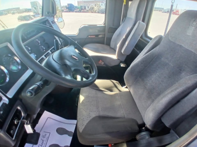 Kenworth T800 truck cab interior showing steering wheel, dashboard gauges, driver seat, and passenger seat