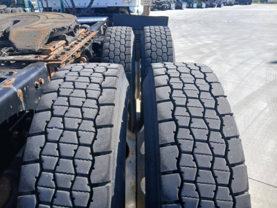 Kenworth T800 tractor rear view showing dual rear axle tires and frame components.