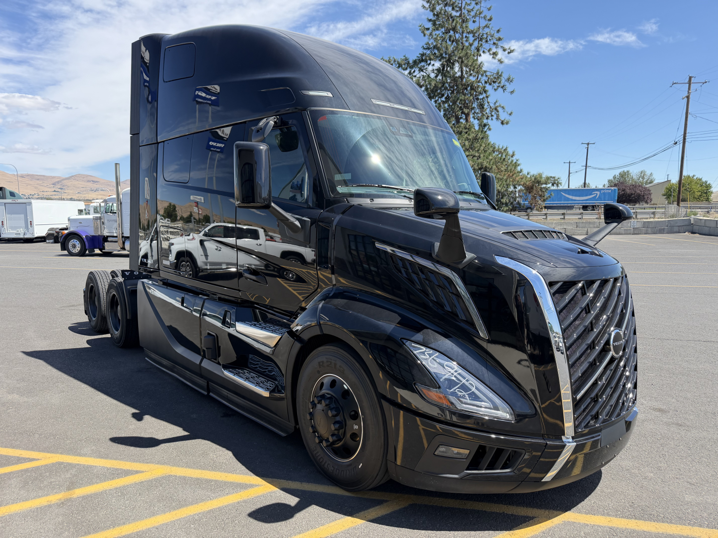 2027 Volvo D11? engine? Actually shows a black Volvo VNL64T860 truck front left view with sleeper cab. No visible textual details on decals besides generic truck design.