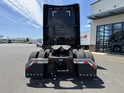 Volvo VNL64T860 tractor rear view showing fifth wheel, dual rear axles, and mudflaps with Volvo branding.