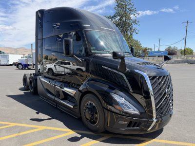 2027 Volvo D11? engine? Actually shows a black Volvo VNL64T860 truck front left view with sleeper cab. No visible textual details on decals besides generic truck design.