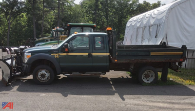Flatbed tow truck side view 2011 Ford F-450 Super Duty Extended Cab with snow plow mounting and utility bed.