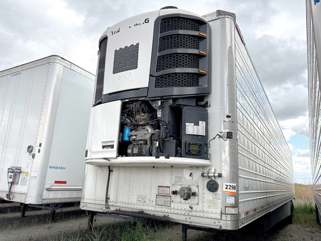 Great Dane Everest SS trailer front view showing refrigeration unit and driver’s area; visible VIN PW443865 and stock 547711; reefer trailer in utility yard.
