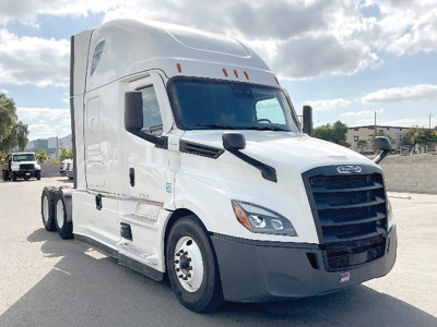 Truck: 2022 Freightliner Cascadia126 sleeper tractor, white, front three-quarter view, VIN plate area and Freightliner emblem visible.