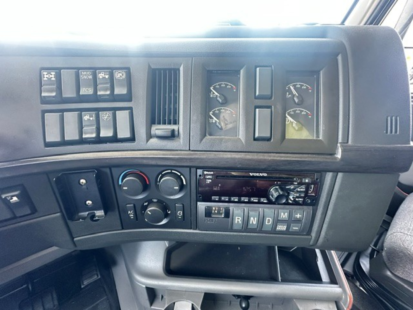 Volvo VNL cab dashboard with gauges, switches, and radio panel visible