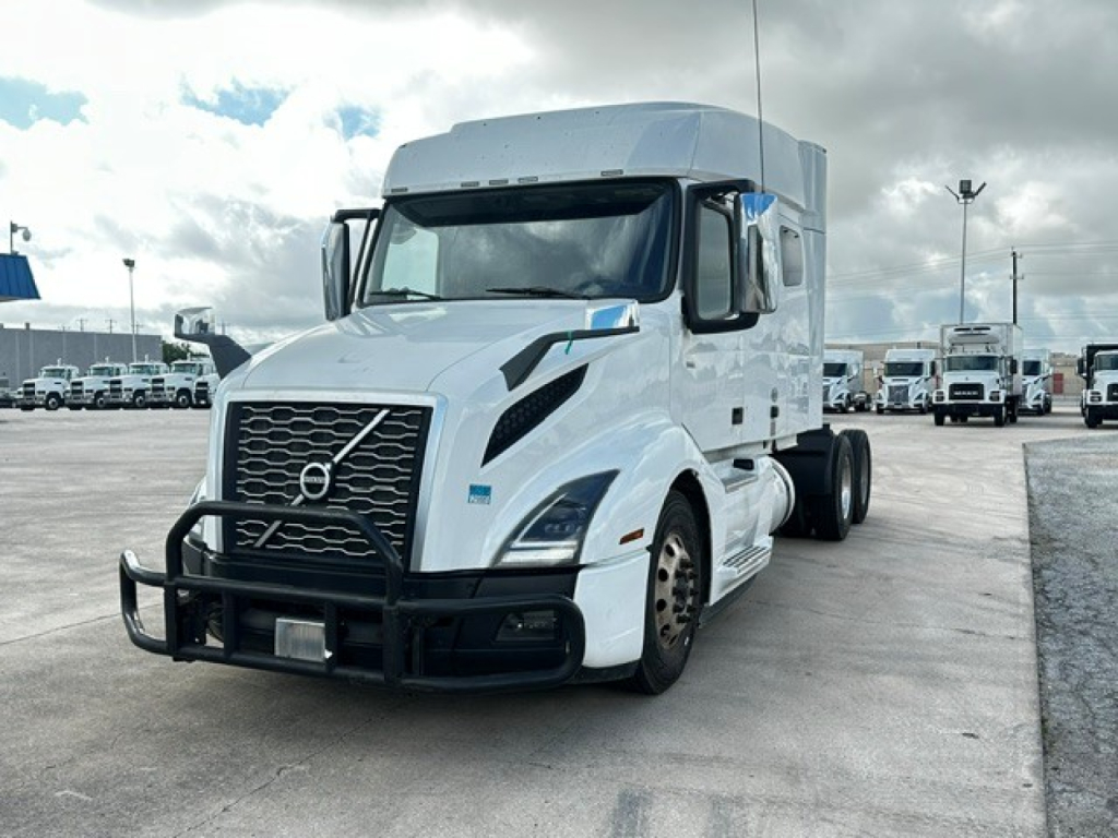 2021 Volvo VNL64T740 semi truck in a lot, front view showing grille, bumper guard, and side mirrors.