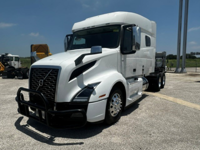 Truck cab in white showing Volvo VNL day cab with grille guard and aerodynamic accents.