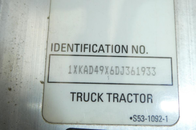 Identification plate showing VIN-like stamp '1XKAD49X6DJ361933' with 'IDENTIFICATION NO.' field and 'TRUCK TRACTOR' label.