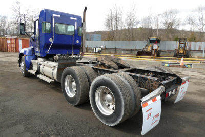 Kenworth T660 chassis rear view showing dual rear axles and open frame with mudflaps