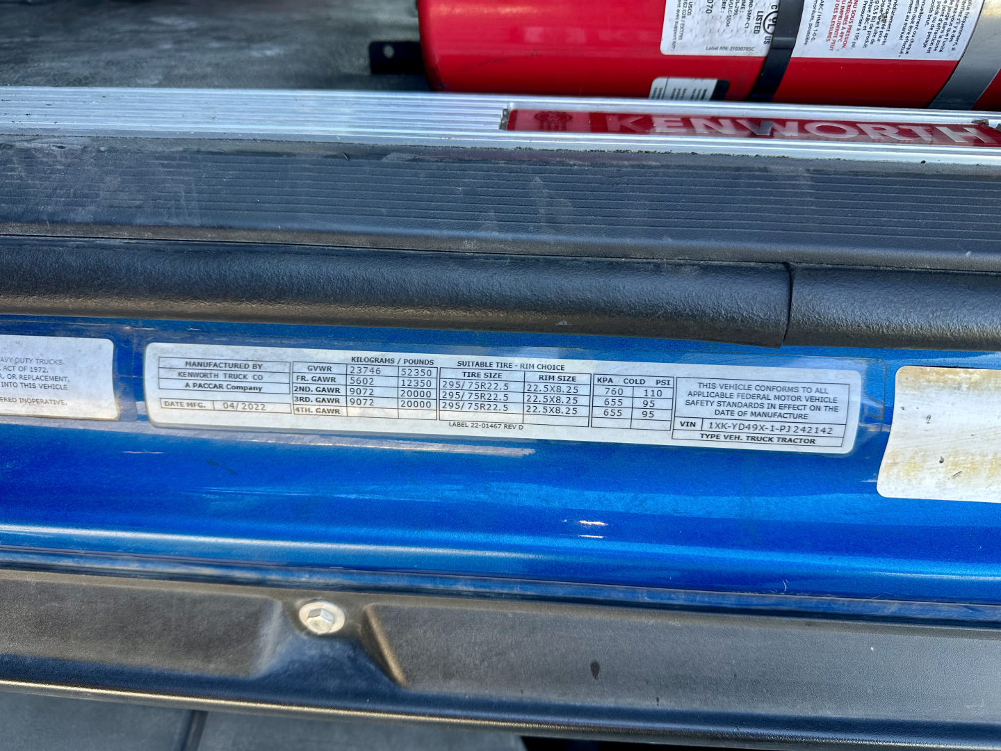 Kenworth T680 truck door sill label showing vehicle specs and VIN information