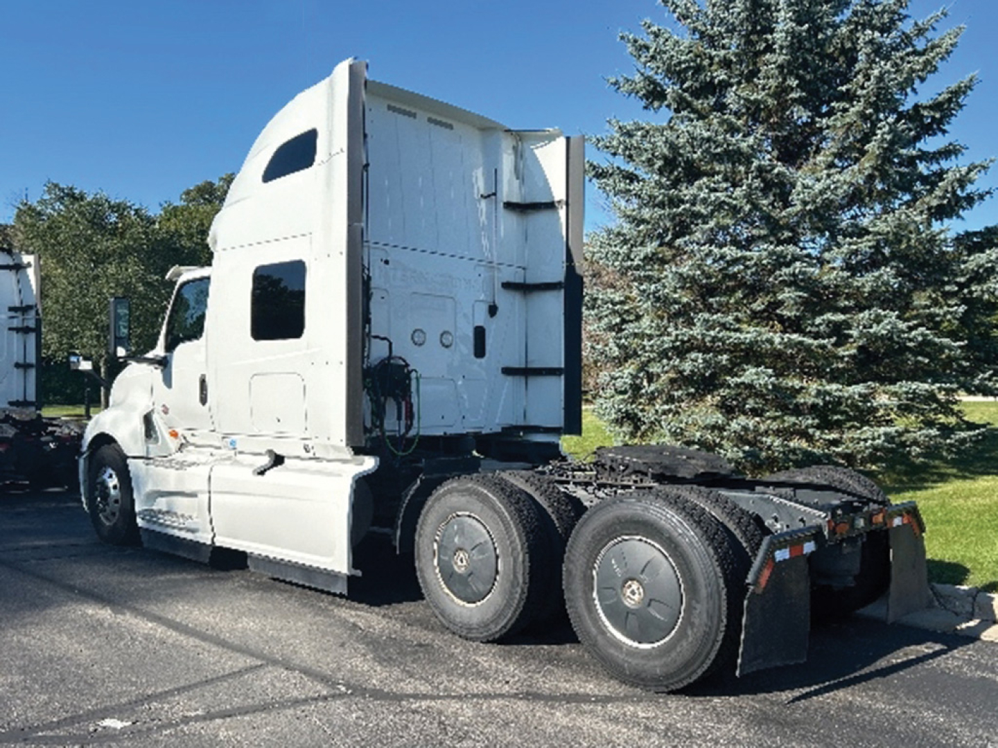 Truck tractor with sleeper cab showing International LT625 badge area, rear dual axles, fifth-wheel area, and tires.